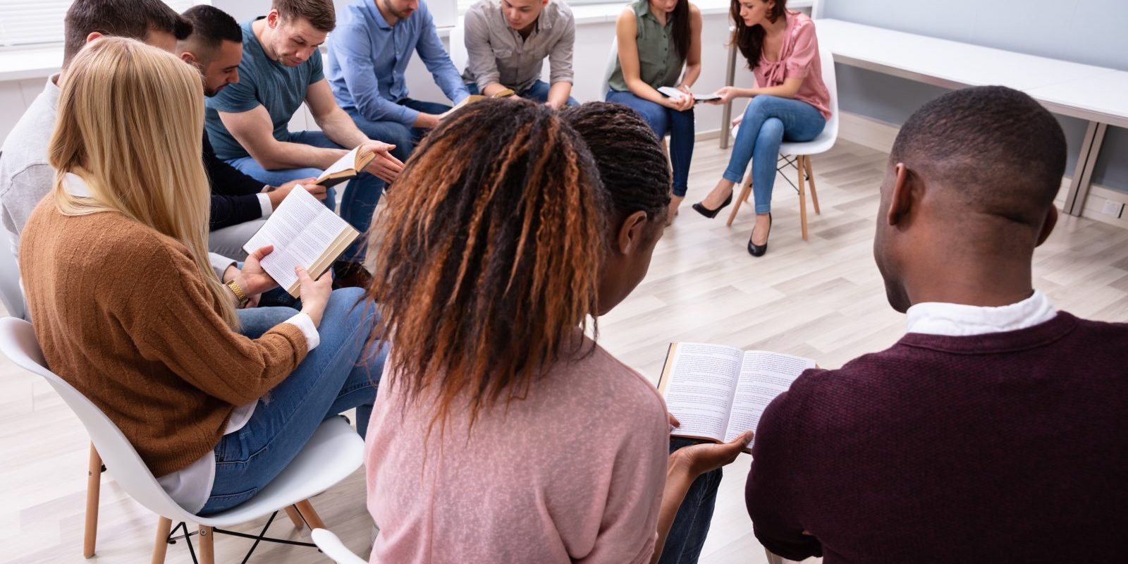 Group Of Young Multi-ethnic People Reading Holy Bible Together