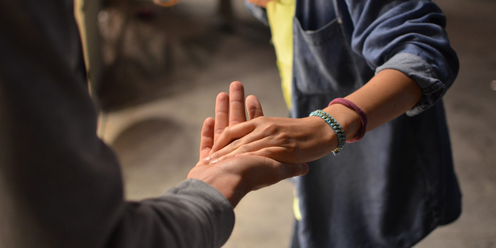 man and woman holding hands on street